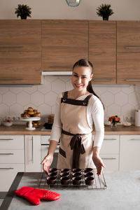 Portrait of chef preparing batter in kitchen