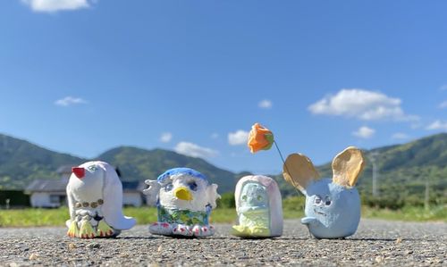 Panoramic view of people on field against blue sky