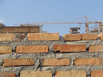 Low angle view of brick wall against clear sky