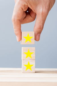 Midsection of person holding toy on table