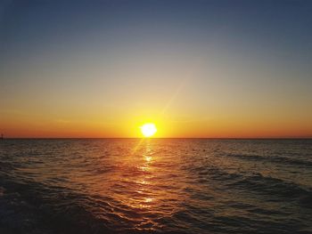 Scenic view of sea against clear sky during sunset