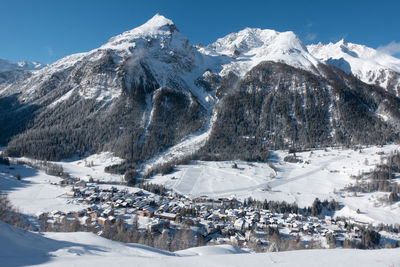 Scenic view of snow covered mountains against sky