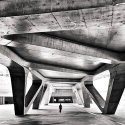 Rear view of people walking on bridge