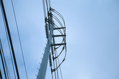 Low angle view of electricity pylon against sky