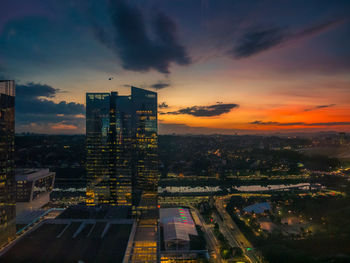 High angle view of illuminated buildings against sky during sunset