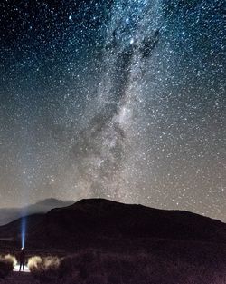 Scenic view of galaxy over landscape