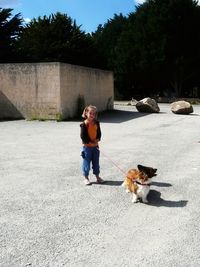 Full length of boy with dog