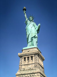 Low angle view of statue against blue sky