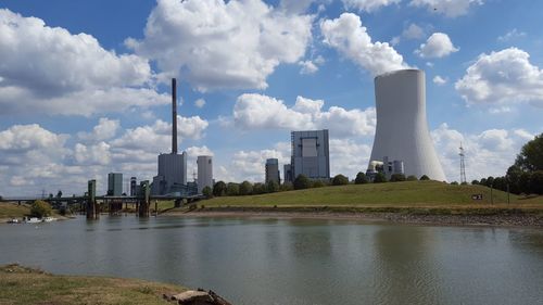 Panoramic view of river by buildings against sky