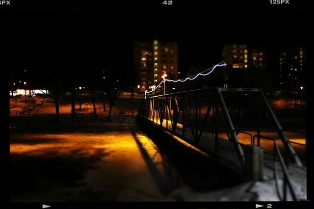 illuminated, night, architecture, city, built structure, building exterior, transportation, street light, reflection, city life, railing, the way forward, dark, street, modern, lighting equipment, bridge - man made structure, outdoors, no people, road