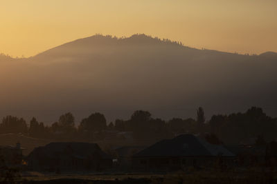 Scenic view of silhouette mountains against sky during sunset