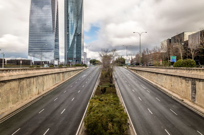 High angle view of highway against cloudy sky in city