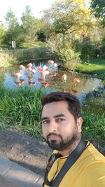 Portrait of young man against plants