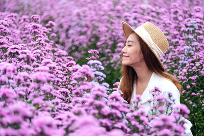 Portrait image of a beautiful young asian woman in margaret flower field