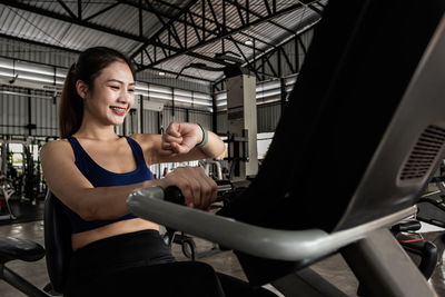 Young woman using mobile phone in gym