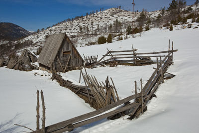 Snow covered land against sky