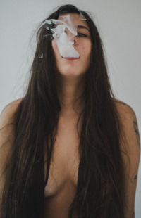 Close-up portrait of a young woman over white background