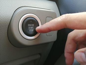 Cropped image of person using laptop in car