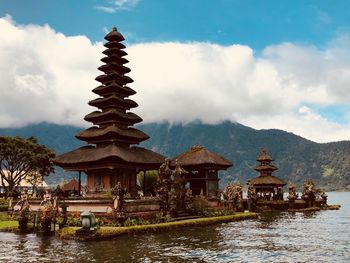 Temple by building against sky