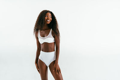 Portrait of young woman against white background