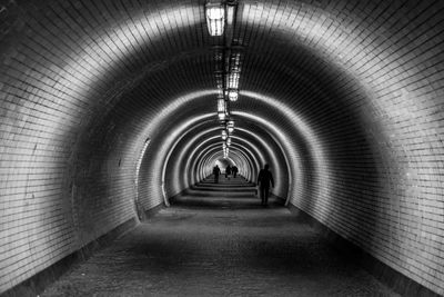 People in illuminated tunnel