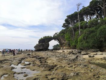 Rocks on beach against sky