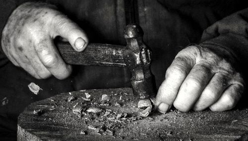 Close-up of man working on metal