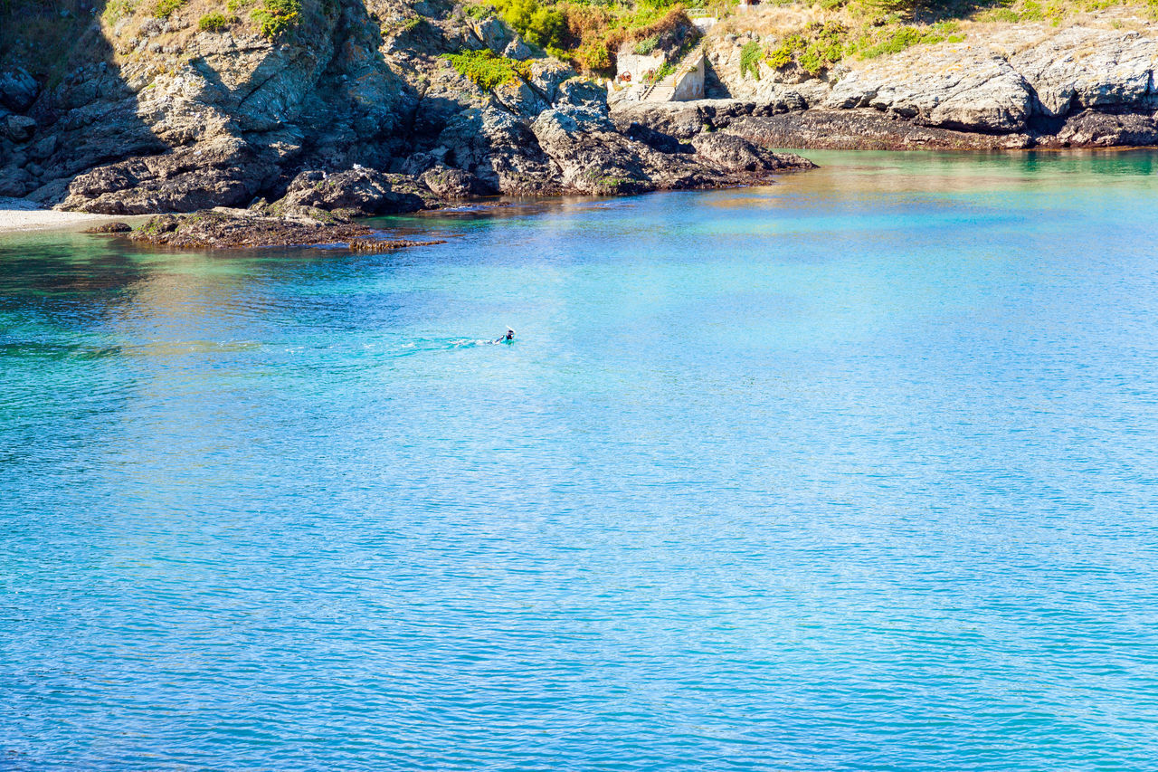 water, beauty in nature, scenics - nature, sea, tranquility, tranquil scene, nature, blue, land, idyllic, day, rock, body of water, waterfront, lagoon, non-urban scene, no people, beach, outdoors, travel destinations, tree, travel, turquoise colored, bay, shore, plant, rippled, rock formation