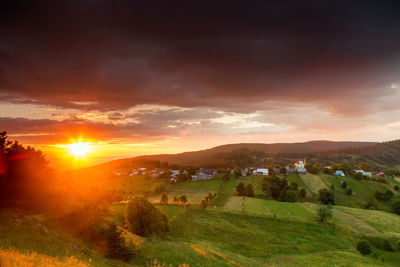 Scenic view of field against sky during sunset