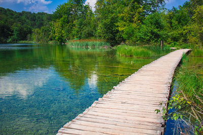 Wooden footpath by lake