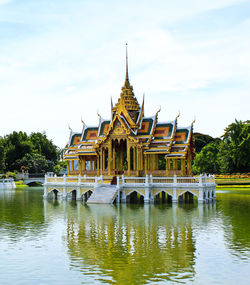 Building by lake against sky