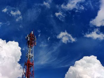 Low angle view of communications tower against blue sky