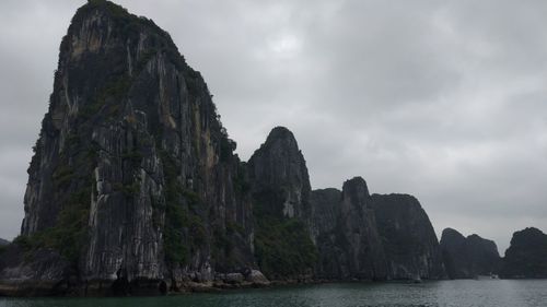 Rock formations by sea against sky