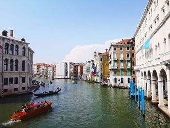 Boats in canal amidst buildings in venice