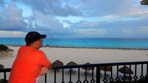 Man standing at beach against sky