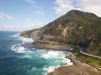 Scenic view of sea and mountains against sky