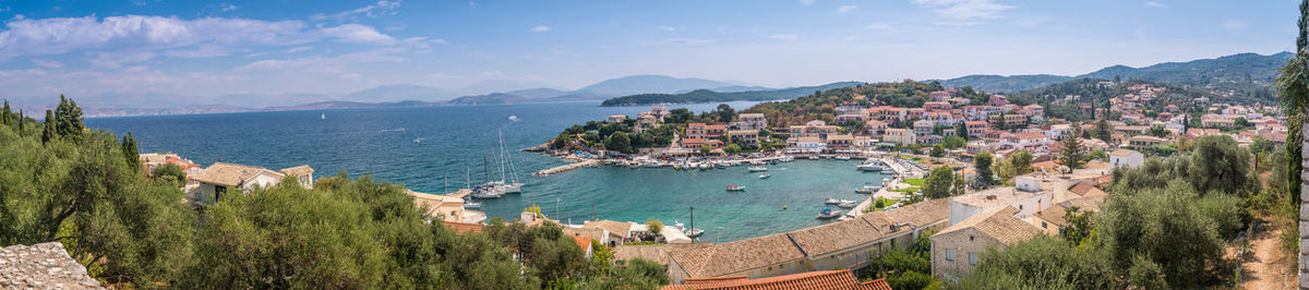 High angle view of town by sea against sky