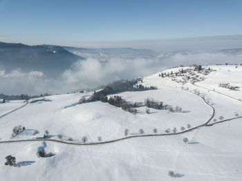 Scenic view of snow covered mountains against sky