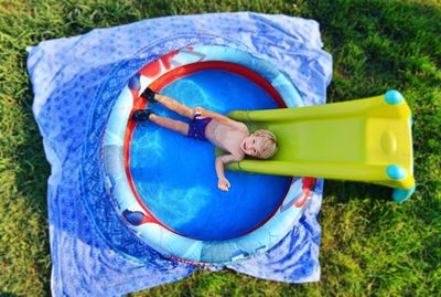 Boy relaxing in wading pool