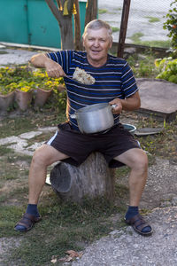 Portrait of a smiling man sitting outdoors