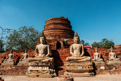 Statues at temple against clear sky