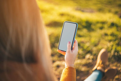 Midsection of person using mobile phone