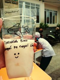 Midsection of man holding ice cream in glass