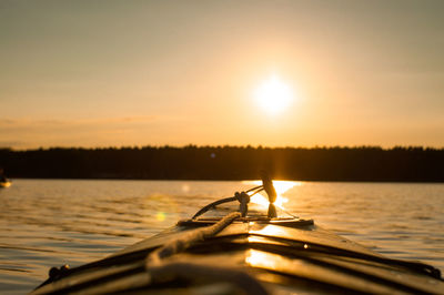 Silhouette boat in sea against sky during sunset