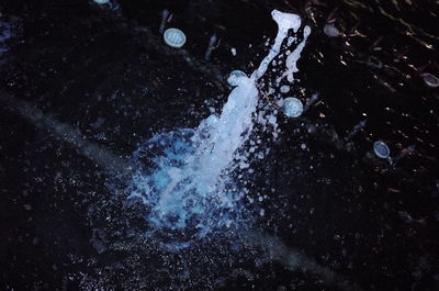 High angle view of water splashing on rock