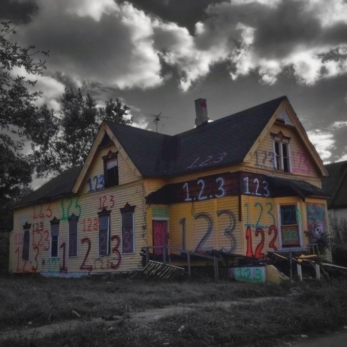 building exterior, architecture, built structure, sky, house, cloud - sky, residential structure, cloud, residential building, cloudy, outdoors, day, no people, low angle view, graffiti, roof, multi colored, window, building, exterior