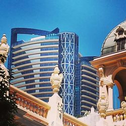 Low angle view of buildings against clear blue sky