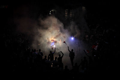 People enjoying event in city at night