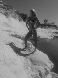 Full length of woman standing on sand