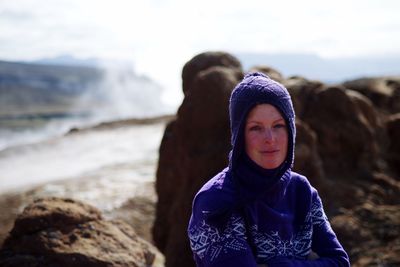 Portrait of woman on rock at beach